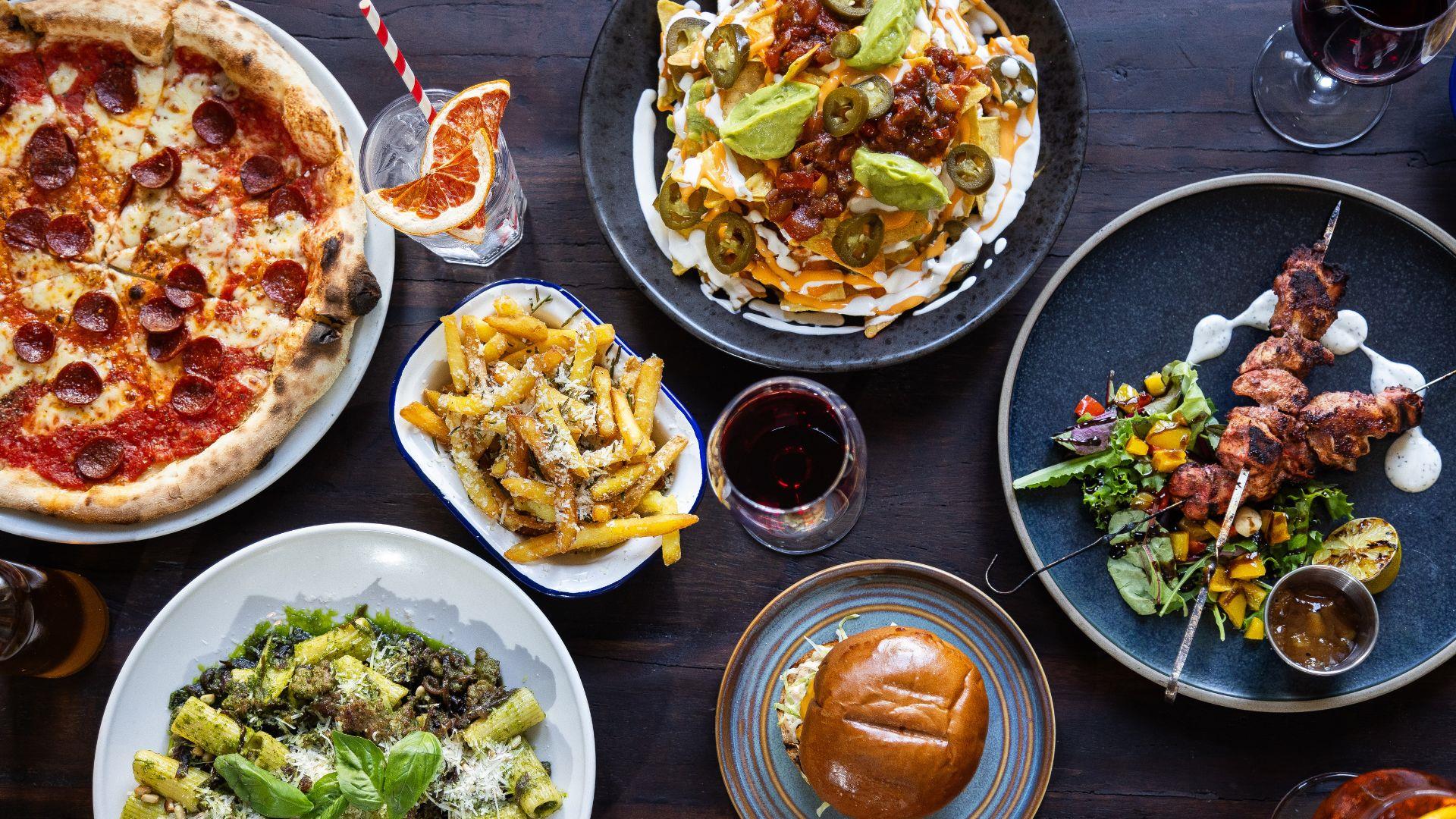 Selection of dishes from above: burger, nachos and pizza