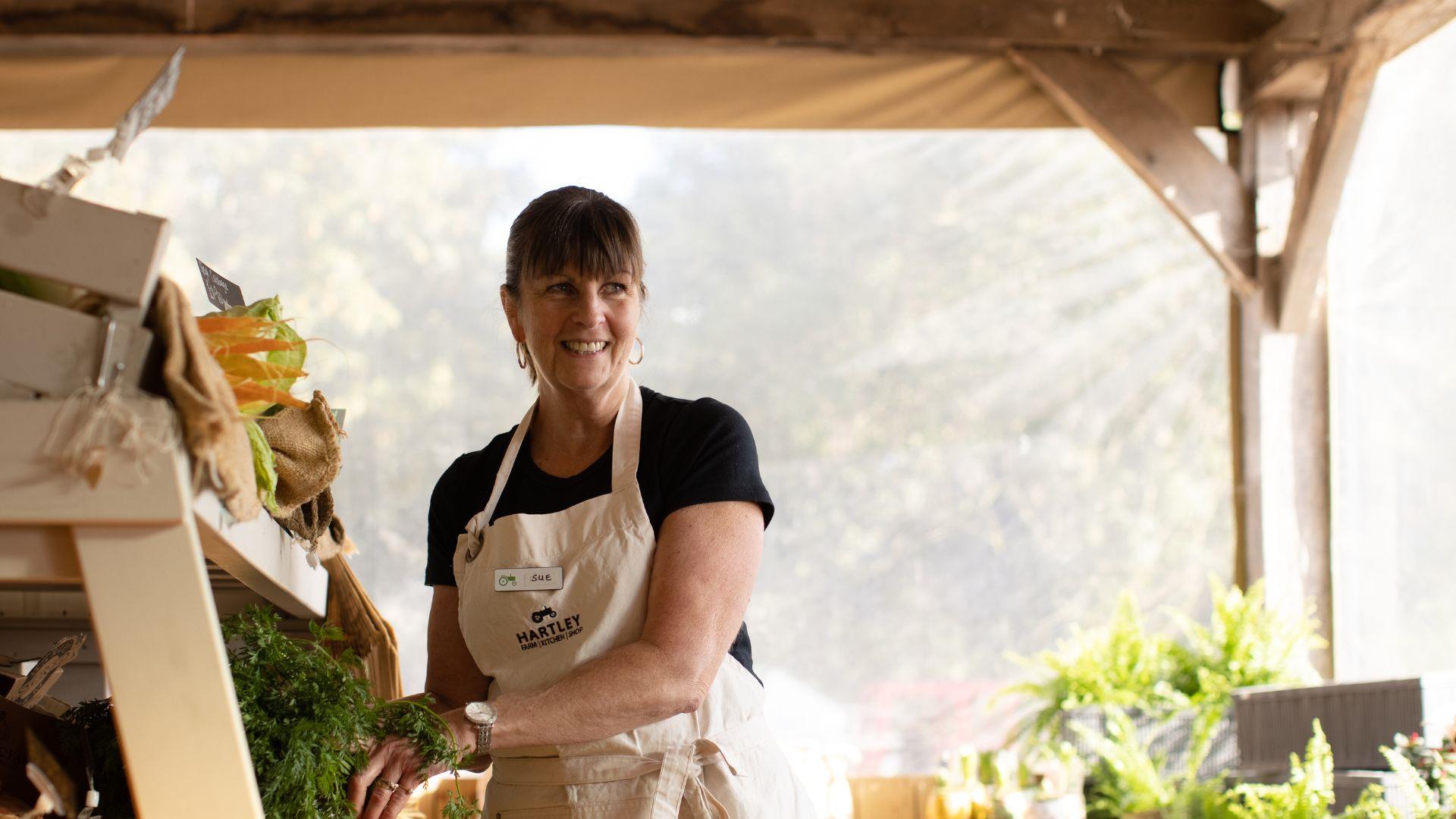 Woman with vegetables at Hartley Farm Shop