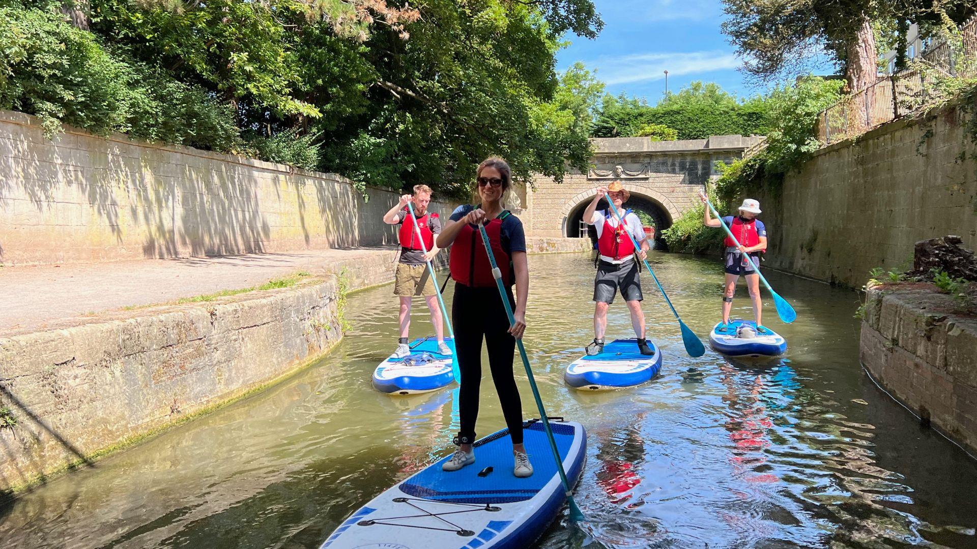 Group paddleboarding on canal