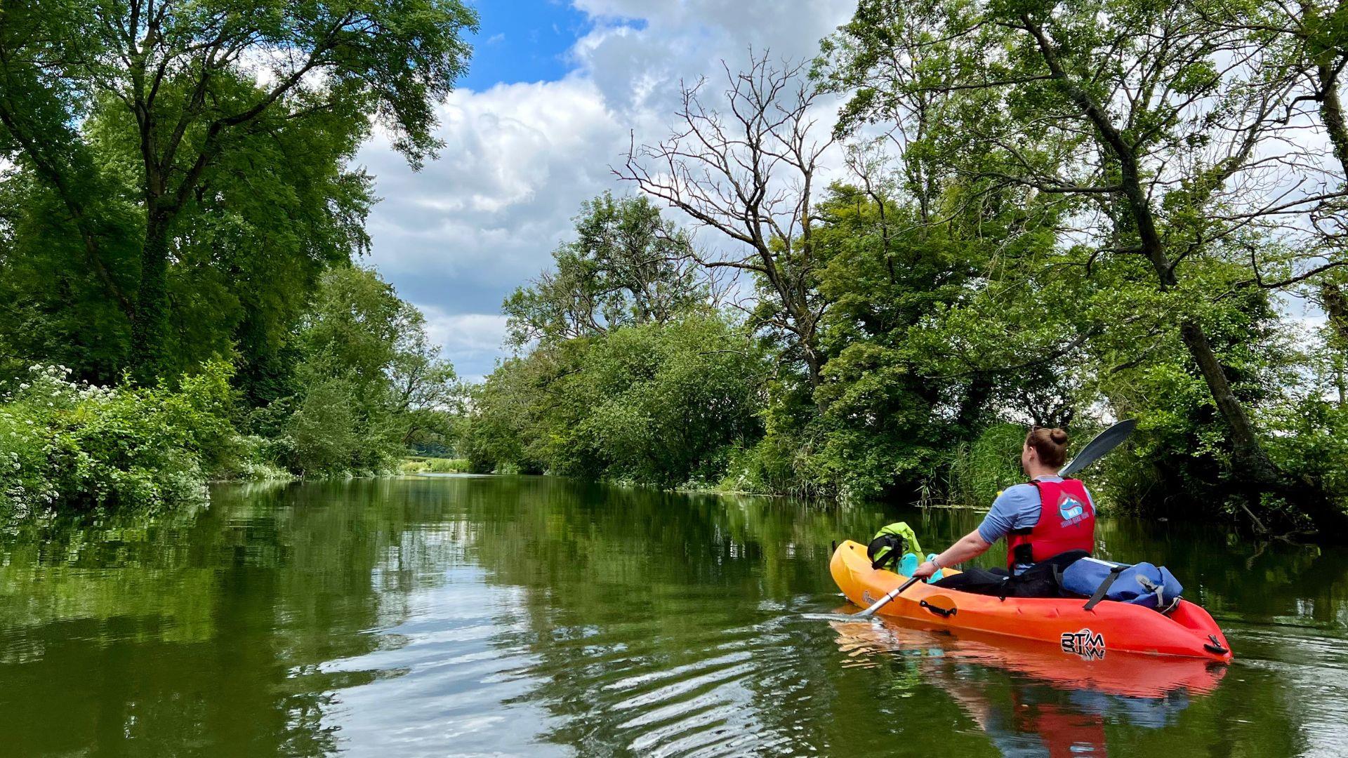 Person kayaking on canal