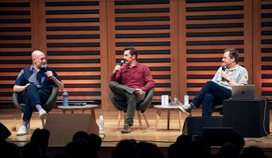 A photo of the Three Bean Salad Podcast members live on stage 