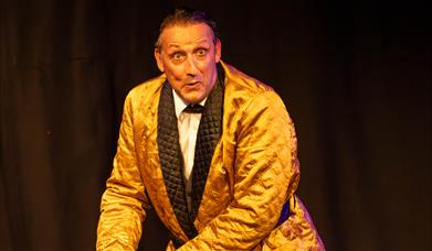 Man wearing gold dinner jacket