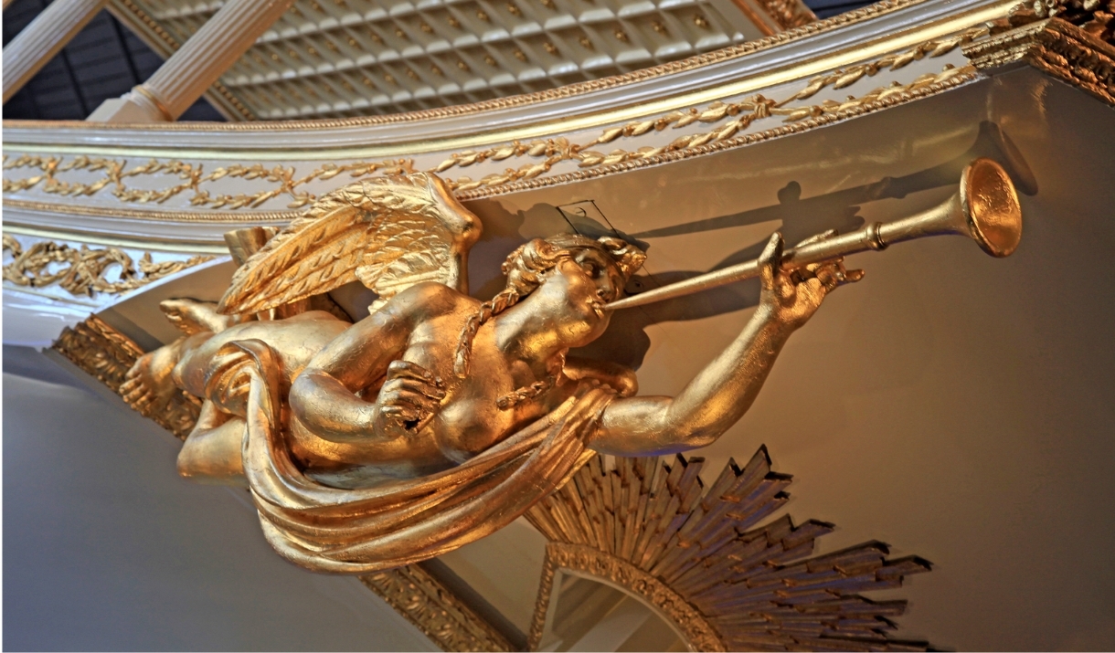 Gold angel statue with a trumpet