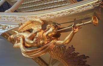 Gold angel statue with a trumpet