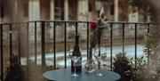 Bottle of wine and glasses with view of Pulteney Bridge