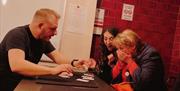 Magician performing a trick for customers