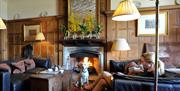 Woolley Grange sitting room, dog in front of fire place