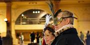 A man and a woman at a masked ball