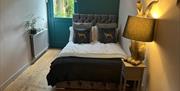 Double Bed in room with lamp