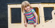 A girl playing in the Motorland outdoor playground at Haynes International Motor Museum