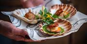 A plate of three scallops with sauces at The Scallop Shell in Bath