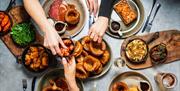 A selection of Sunday roast dinner dishes on a table at The Botanist Bath